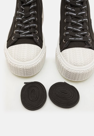 Black high-top sneakers with white textured rubber soles, featuring black laces and brand logo accents. Includes two black shoelaces.
