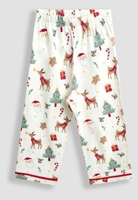 Pantalones de pijama impresos en color crema claro con motivos festivos de renos, Santa, árboles de Navidad, bastones de caramelo y regalos. Cintura elástica.