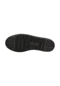 Black rubber shoe sole with textured grip patterns, featuring horizontal and vertical lines, rounded toe, and embossed logo detail.