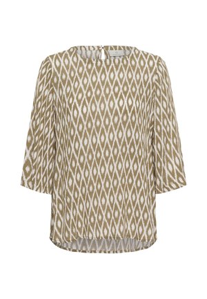 Blouse beige et blanche à manches longues avec motif géométrique en forme de losange et petite fermeture à bouton dans le dos.