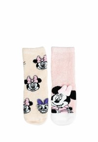 Calze pelose in rosa chiaro e beige. Una calza presenta disegni di Minnie Mouse; l'altra è di un rosa uniforme con una grafica di Minnie e un accento a forma di fiocco.