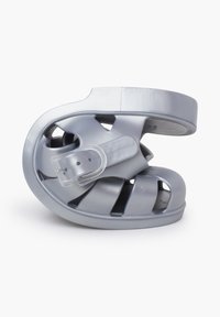 Gray molded shoe with a coiled design, featuring ventilation cutouts and a strap with a buckle accent. Smooth, glossy finish.