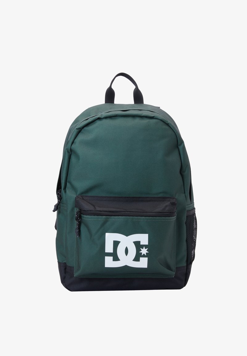 Green fabric backpack with a black bottom, featuring a white DC logo, a front pocket, and mesh side pockets for water bottles.