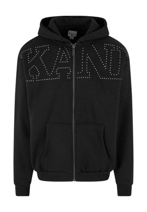 Black zip-up hoodie made of soft fabric, featuring large studded lettering "KAND" on the chest and kangaroo pockets.
