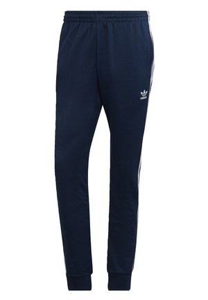 Pantaloni jogger blu navy realizzati in tessuto morbido, con accenti bianchi a tre strisce lungo i lati e una vita elasticizzata.