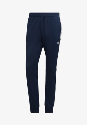 Pantaloni jogger blu navy realizzati in tessuto morbido, con accenti bianchi a tre strisce lungo i lati e una vita elasticizzata.