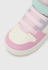 Colorful sneaker featuring pink, lavender, and mint accents, made of synthetic leather with mesh detailing, flat laces, and perforated toe.