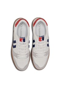 White and grey athletic shoes with navy stripes, featuring leather and suede materials, round toe, rubber sole, and red accents on the heel.