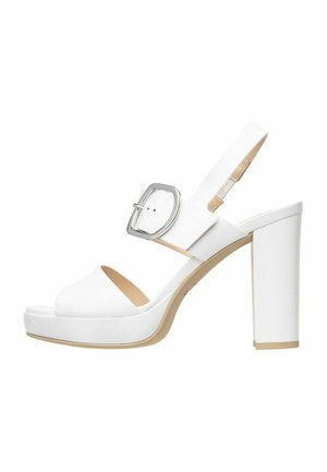 White high-heeled sandal with a platform, open toe, and ankle strap featuring a silver buckle. Smooth texture, block heel, and minimalist design.