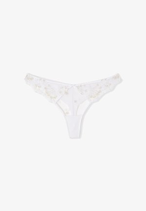 White lace thong underwear with delicate floral embroidery and a small center bow, displayed on a plain white background.