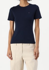 Navy blue short-sleeve t-shirt made of cotton with a fitted design, featuring a small logo on the chest and a classic crew neckline.