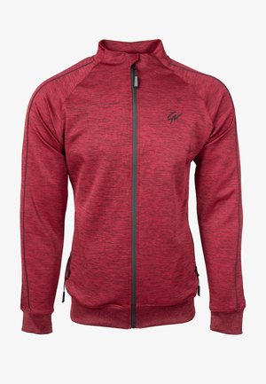 Rode ritsjack gemaakt van textuurstof, met een hoge kraag, zwarte accenten, zijzakken en een logo op de borst.