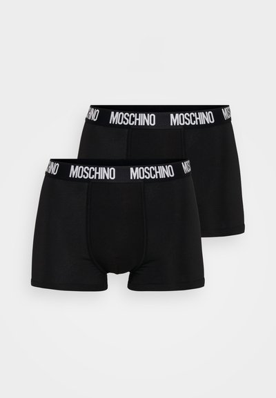 Mustvalged pokud musta Moschino logo valge elastse vööga. Sile kangas, kehakaarduv disain ja reide ulatuv pikkus. Komplektis on kaks tükki.
