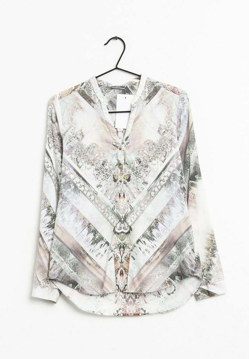 Long-sleeve blouse in light colors with intricate, abstract patterns. Features a V-neckline and rounded hem, made of smooth fabric.