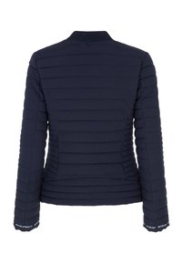Navy blue puffer jacket featuring quilted design, ribbed collar, and elastic cuffs with logo accents. Smooth fabric with lightweight insulation.