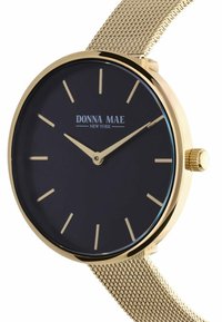 Polshorloge in goudkleur met een zwarte wijzerplaat, minimalistische uuraanduidingen en een meshband. Voorzien van een gouden kroon voor het instellen van de tijd.