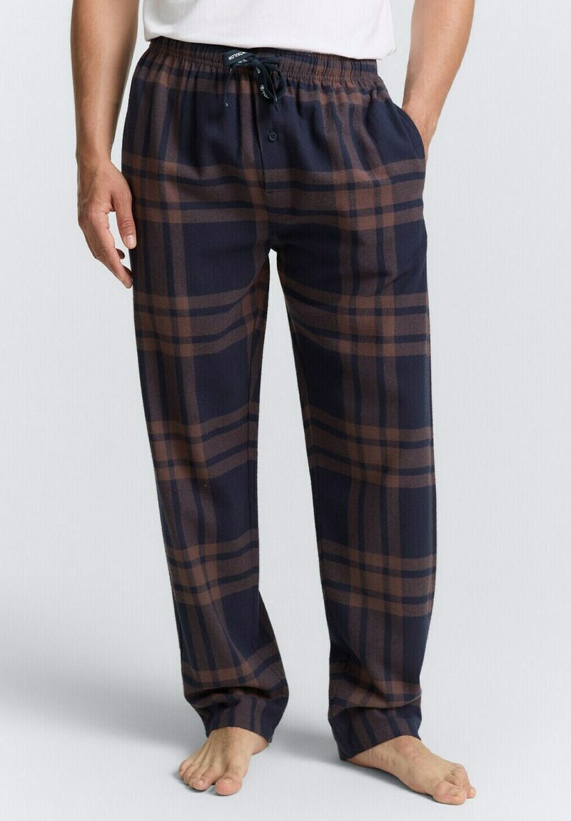 Marineblauwe geruite pyjamabroek met bruine strepen, zachte stof, elastische tailleband met trekkoord, zijzakken, losse pasvorm en knoopsluiting.