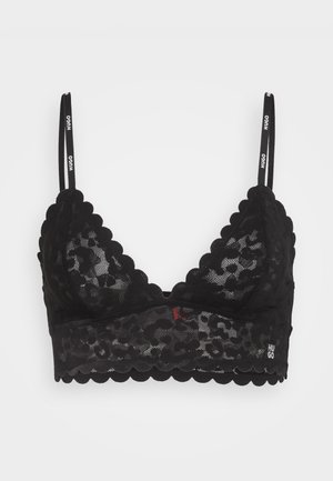 Black lace bralette featuring scalloped edges, thin adjustable straps, and a signature logo on the band, with a floral pattern.
