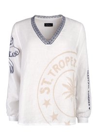White linen top with a V-neck and patterned neckline. Features beige and navy graphic prints, including "ST.TROPEZ" and palm tree design.