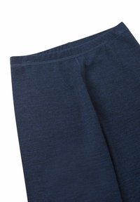 Close-up of dark blue fabric leggings with visible stitching details on a white background.