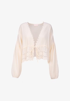 Gekürzte cremefarbene Bluse mit V-Ausschnitt, langen Puffärmeln, Spitzendetails und einer Krawattenverschluss. Verfügt über ein strukturiertes Gewebe und einen gewellten Saum.