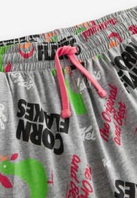 Gray cotton shorts with a drawstring in pink. Features colorful prints of food icons and text, including "Corn Flakes" in black.