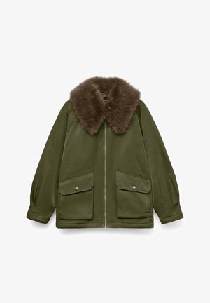 Chaqueta verde oliva con un cuello de piel sintética marrón, cierre de cremallera y dos grandes bolsillos frontales. Textura suave y corte relajado.