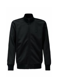 Chaqueta negra con cremallera y cuello alto, confeccionada en un material suave, con puños acanalados y un pequeño logotipo en el pecho.