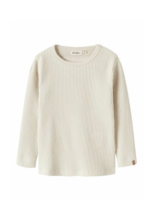 T-shirt côtelé à manches longues de couleur crème avec col rond et petite étiquette en cuir sur le poignet de la manche gauche.