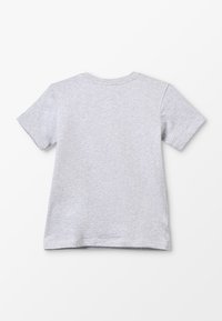 Harmaa lyhythihainen T-paita pehmeästä kankaasta, jossa klassinen pyöreä kaula-aukko ja suora helma sivuhalkioilla.