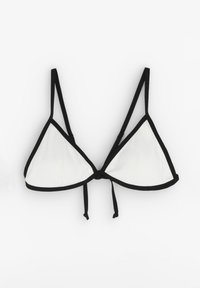 Zwart-wit driehoekig bikini topje met ribbelstructuur, dunne zwarte banden en een strik achteraan, met contrasterende randafwerking.