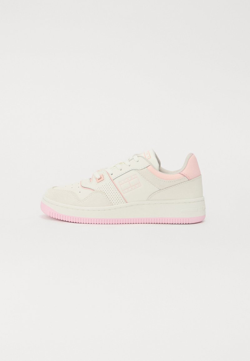 White and light pink sneaker with a textured surface, lace-up design, and perforated accents. Features a pink rubber sole and logo detail.