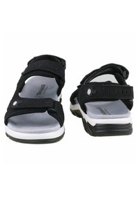 Black sandals with adjustable straps, cushioned insoles, and a white midsole. The design features a textured surface and a durable rubber outsole.