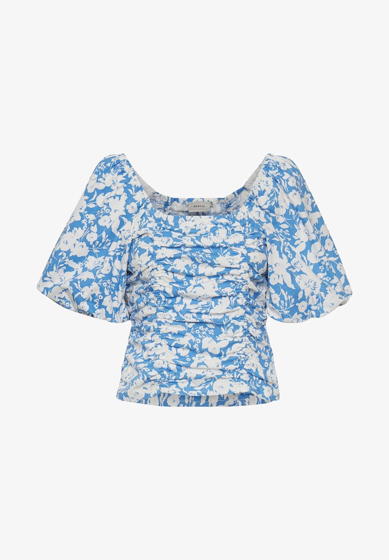 Blouse fleurie en bleu clair et blanc, avec un design froncé, des manches courtes bouffantes et un décolleté carré. Tissu à texture douce.