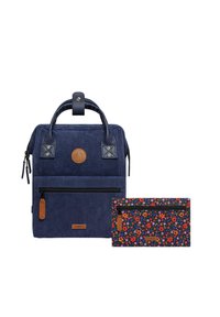 Navy corduroy backpack with leather accents, featuring a front zipper pocket and a detachable floral-patterned wallet in vibrant colors.