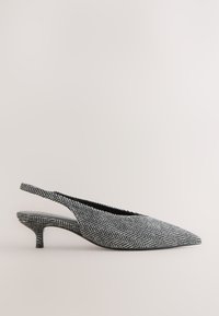 Slingback bateliai juodos ir baltos žąsies pėdų raštu, smailiu priekiu, žemu katinuko kulniuku ir tekstūruotu audinio viršumi.