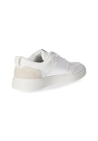 White leather sneaker with a textured white rubber sole. Suede accent panel at the heel. Lace-up closure with perforated detailing on the side.