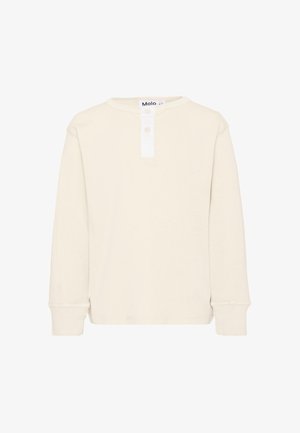 Chemise manches longues couleur crème avec col rond et patte de boutonnage blanche, présentée sur fond blanc uni.