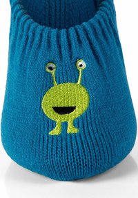 Pantofole lavorate a maglia color teal con bordo elasticizzato, decorate con un alieno cartoon verde ricamato, con grandi occhi e un sorriso.