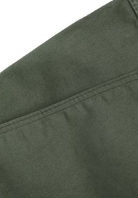 Olivgrüner Stoff mit glatter Textur, der entlang der Nähte ordentlich gestickt ist. Keine sichtbaren Muster oder Verzierungen.