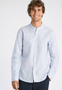 Camicia a maniche lunghe a righe in blu chiaro e bianco, con colletto alto e bottoni. Tessuto morbido con taglio dritto e bottoni bianchi.