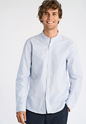 Camisa de manga larga a rayas en azul claro y blanco, con cuello alzado y botones. Textura suave con un corte recto y botones blancos.