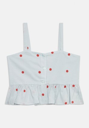 Débardeur blanc court avec fines bretelles, pois rouges, boutons à l'avant et ourlet volanté le long du bord inférieur.