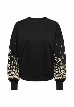 Mustaga pusaga, millel on pikad varrukad, kus on kreemjad lilleline tikandid varrukatel ja soonilised äärised, valmistatud pehmest ja tekstuurist kangast.