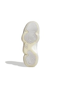 Semelle de chaussure avec un design blanc et crème. Motifs texturés avec des spirales et des découpes circulaires pour une meilleure adhérence. Présente le logo de la marque en marron.