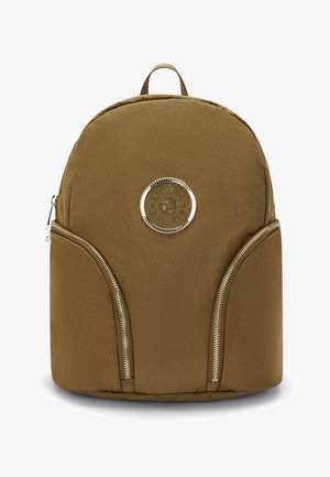 Khaki fabric backpack with a rounded shape, featuring two front zip pockets and a round logo in the center. Smooth texture and minimalistic design.