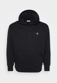 Black hoodie made of soft fabric, featuring a front pocket, drawstring hood, and a small white logo on the chest.