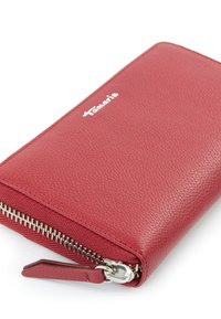 Red leather wallet with a textured surface, a silver zipper, and a logo embossed on the front. Compact design for easy handling.