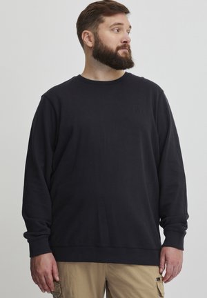 Black crewneck sweatshirt made of soft fabric with a relaxed fit, featuring ribbed cuffs and hem, and a small logo on the chest.