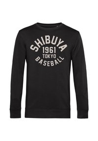 Felpa nera a maniche lunghe in cotone. Presenta testo bianco: "SHIBUYA 1961 TOKYO BASEBALL" disposto in modo curvo sul davanti.